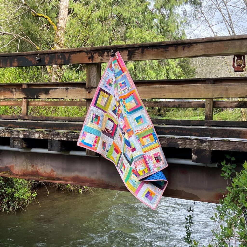 Colorful Handmade Log Cabin Quilt Draped on Rustic Bridge, Salem