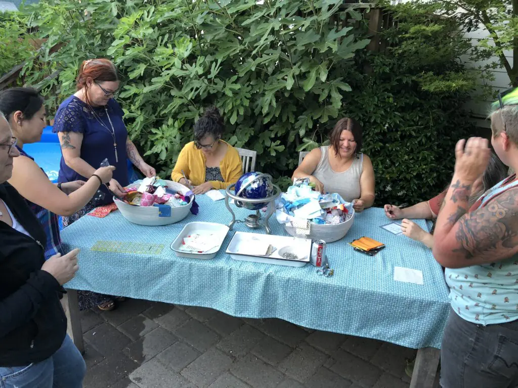 Women Gathering to Assemble Adoption Quilt in Backyard