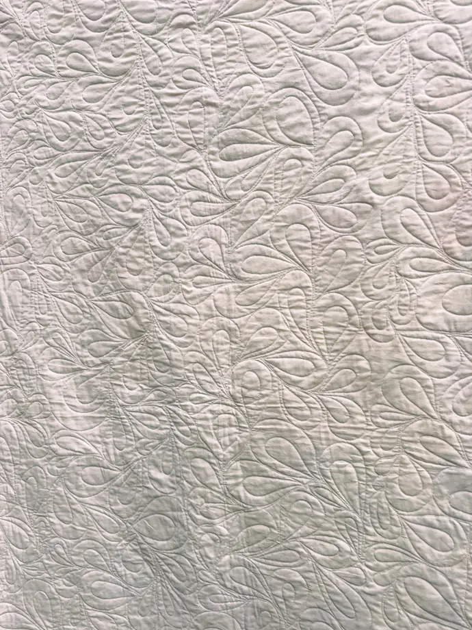 Learning Quilting White Quilt with Feathered Stitching