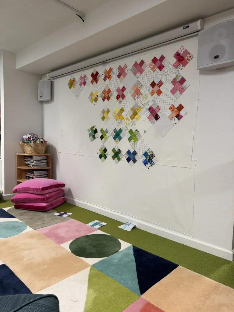 Crosses on Point quilt layout on design wall in sewing studio